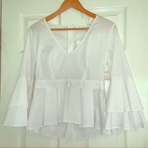 White peplum blouse. Deep V neck.  Size Medium